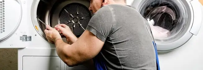 Dryer repair technician fixing a clothes dryer drum in Memphis, TN