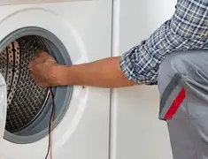 Dryer repair technician diagnosing and servicing a clothes dryer in Memphis, TN